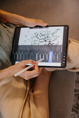 Artist or designer making new project, drawing on a graphic tablet with pencil, close-up on a screen.