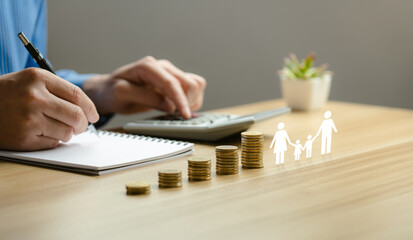 Family finance plan concept, businessman putting coin and icon family on table, donation, saving, charity, fundraising, superannuation, investment, fund, financial crisis concept.