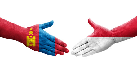 Handshake between Monaco and Mongolia flags painted on hands, isolated transparent image.