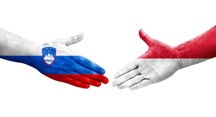Handshake between Monaco and Slovenia flags painted on hands, isolated transparent image.