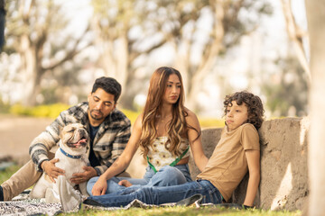 Family and small dog enjoying in a park