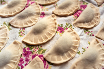 Pirohy, pierogi, sweet filled dumplings, dough, rustic Slovak kitchen cloth detail, grandma's recipe