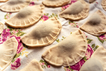 Pirohy, pierogi, sweet filled dumplings, dough, rustic Slovak kitchen cloth detail, grandma's recipe