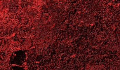 A textured background featuring deep red tones with a distressed, grunge appearance. The surface shows scratches and uneven patterns, creating a vintage feel.