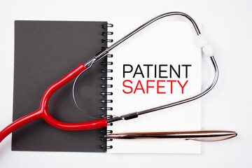 Patient Safety - text concept on notepad with medical stethoscope. Medical concept of PATIENT SAFETY.