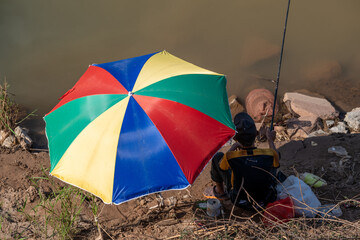 Colorful Parasol and Umbrella with Fisherman. 