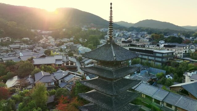 Japanese town of Kyoto at sunrise, aerial view of Yasaka pagoda, famous Japanese tourist destination in the morning, flying around famous shrine of Yasaka pagoda