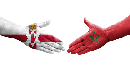 Handshake between Morocco and Northern Ireland flags painted on hands, isolated transparent image.
