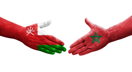 Handshake between Morocco and Oman flags painted on hands, isolated transparent image.