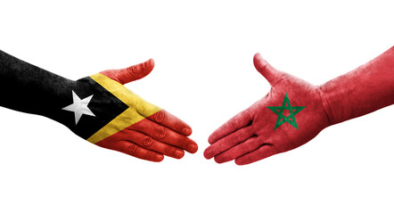 Handshake between Morocco and Timor Leste flags painted on hands, isolated transparent image.