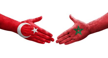 Handshake between Morocco and Turkey flags painted on hands, isolated transparent image.