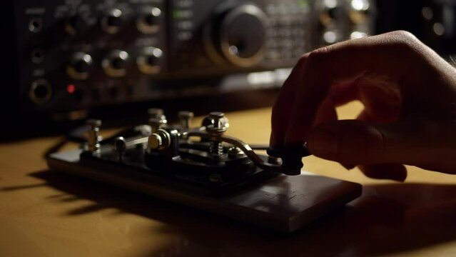Morse Code Radio Telegraphy CW Ham Radio Straight Key with Radio in the Background