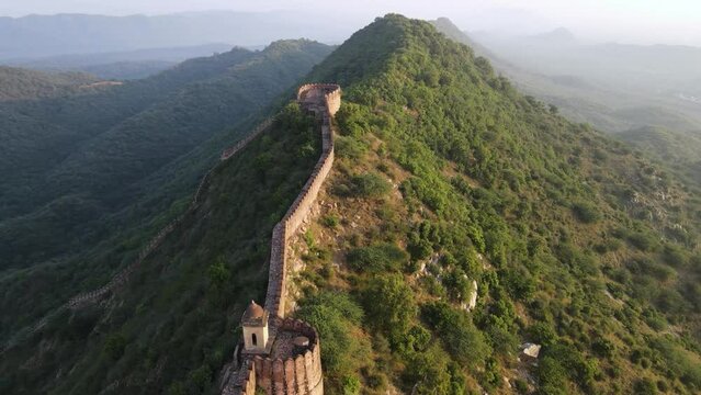 aerial view of amer town in jaipur city drone revealing mountain hill cliff with old town and  fort