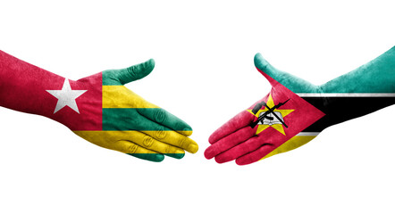 Handshake between Mozambique and Togo flags painted on hands, isolated transparent image.