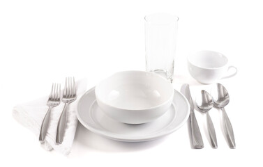 A Table Set with a Clean and Emtpy White Set of Dishes and Silverware Isolated on a White Background