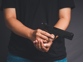 Man holding a gun ready to shoot for self-defense the criminal concept