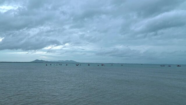 Planes from U-Tapao Airport over Samaesan Bay..airplane above fishing boats and barges moored in Samaesan harbor .that shelters waves and storms. .Cargo and fishing boats are therefore parked.