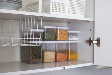 House decor ideas. Storage in the kitchen. Home organization. White shelf and modern interior.