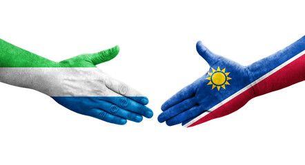 Handshake between Namibia and Sierra Leone flags painted on hands, isolated transparent image.