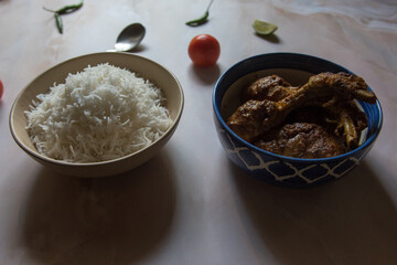 Popular Bengali lunch menu white rice and chicken masala. Close up, selective focus.