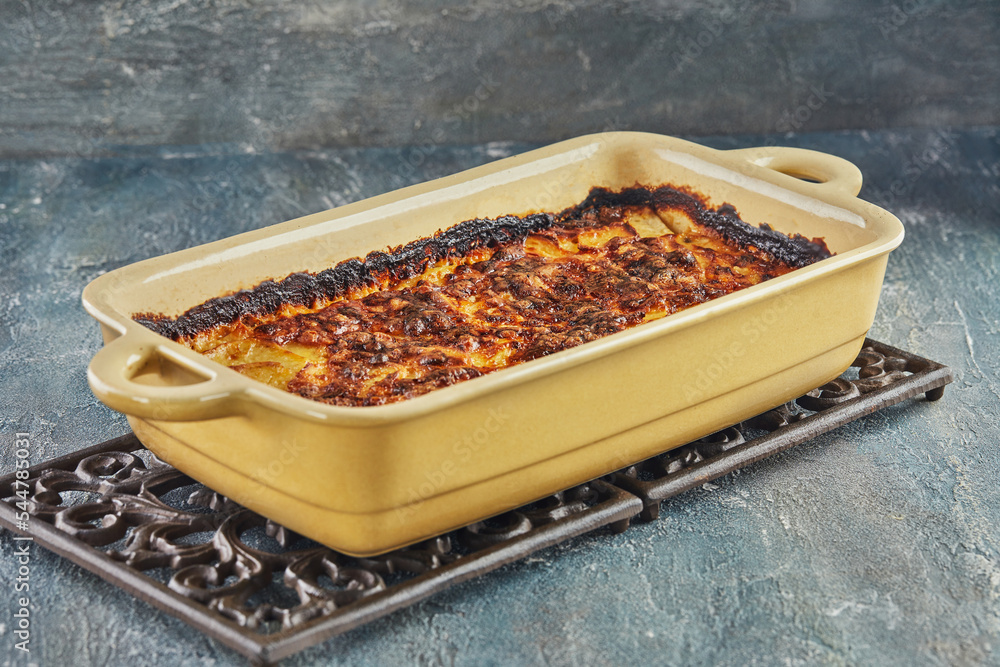 Sticker Potato and sweet potato gratin with Provence herbs is baked in the oven. French gourmet cuisine