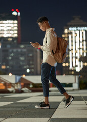 Night, man and phone while walking in a city with social media, networking and searching the...