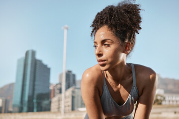 Fototapeta na wymiar Fitness, runner and tired black woman in a city sweating from running exercise, cardio workout or training. Breathing, fatigue and sports athlete relaxing or resting on a break on a sunny summers day