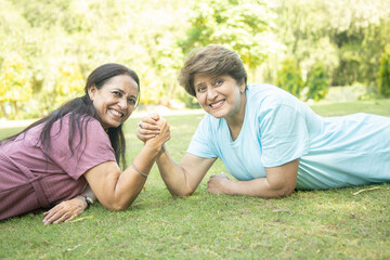 Senior Indian women Arm Wrestling Game With Each Other At Park Outdoor. Retirement life. Playful...