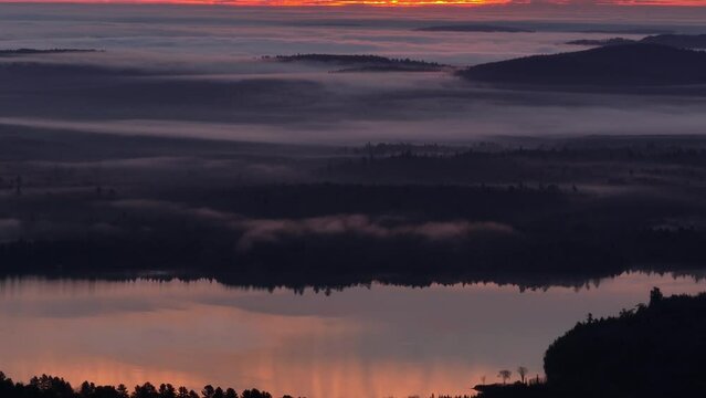 Golden hour sunrise illuminates low cloud cover over Monson