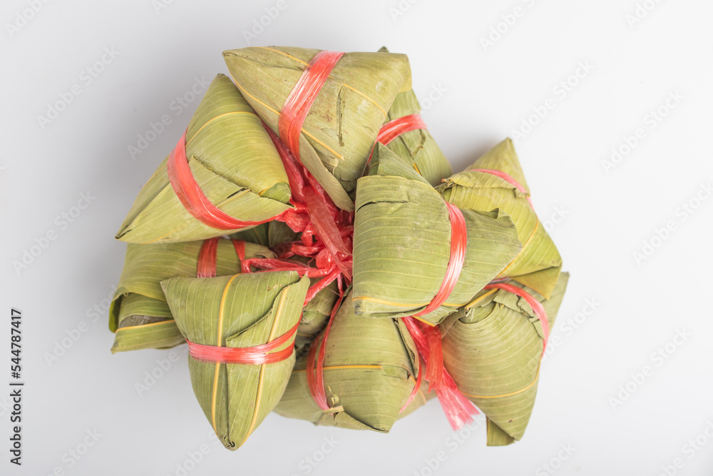 Wall mural ba zhang steamed in a steamer chinese national food bamboo leaves background