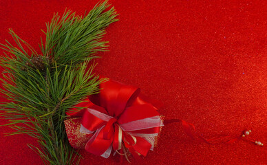 Red Christmas background with Christmas tree branch and Christmas balls and toys