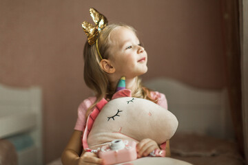 beautiful girl with unicorn in her children's room