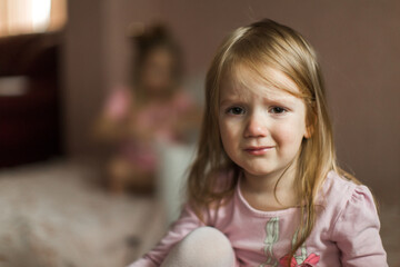 sisters quarreled and sit apart on different beds