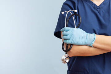 Female doctor in uniform with stethoscope on a blue background - obrazy, fototapety, plakaty