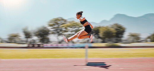 Athlete, sports and woman jump hurdle for track and field event for obstacle race or course for...