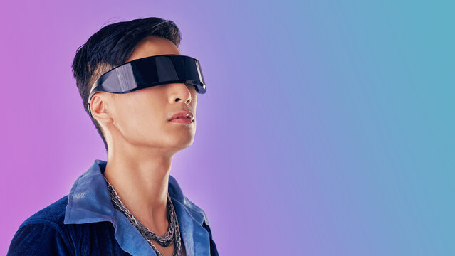 Beauty, fashion and man with cyberpunk glasses in studio with blue and purple background. Creative, cosmetics and young male model with visor for futuristic style, techno and designer clothing