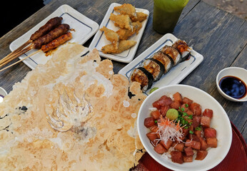 Izakaya(Japanese style street food) Chicken teriyaki skewers, Battered deep fried Flying fish, Sushi Maki rolls, Kaisen Don(Sashimi rice bowl), Senbei(Squid rice cracker) and Iced Green Tea