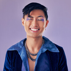Fashion, color and man in studio for punk, retro and pop art style while feeling happy with makeup and vintage clothes on a purple background. Lgbtq, gen z and asian aesthetic model with makeup