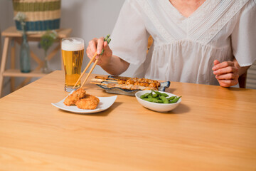 ビールで晩酌をするミドル女性