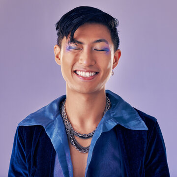 Fashion, Color And Man In Studio For Punk, Retro And Pop Art Style While Feeling Happy With Makeup And Vintage Clothes On A Purple Background. Lgbtq, Gen Z And Asian Aesthetic Model With Makeup