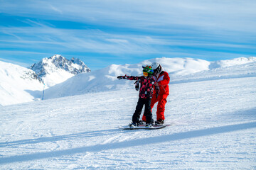 Boy and Instructor on Snowboarding Class