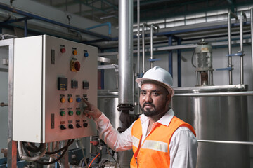 South Asia male factory worker or Man engineer or expert staff is maintenance and checking control...
