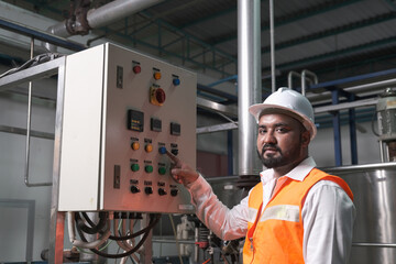 South Asia male factory worker or Man engineer or expert staff is maintenance and checking control...