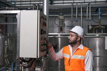South Asia male factory worker or Man engineer or expert staff is maintenance and checking control...