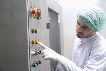 Asian male factory worker or Man engineer or expert staff is maintenance and checking control system