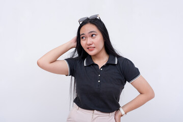 A young confused asian woman on her wits end. Scratching her head, unsure what to do. Isolated on a...