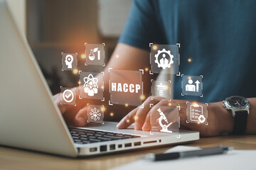 Businessman using a computer to HACCP - Hazard Analysis and Critical Control Points, Management system in which food safety.