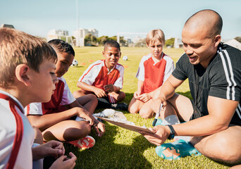 Soccer, football coach with team talk and strategy with tactics winning game sitting on grass training field. Boy children athletes, teamwork and motivation to win youth kids sport competition match