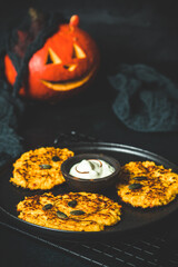 Baked pumpkin fritters served with sour cream