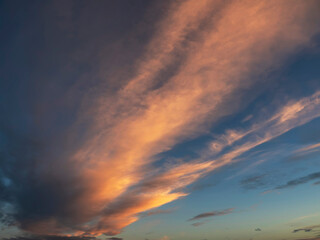 Dramatic sunset sky for design purpose of sky replacement. Nature background. Rich dark blue and warm orange color tone.